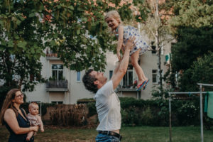 Familienfoto von Familie im Hinterhof, natürliches Familienfoto entstanden bei Familienfotoshooting in Freiburg